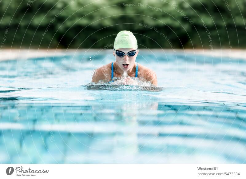 Young woman swimming in swimming pool, breast-stroke swimming summer summer time summery summertime swimmer female swimmers fitness Activity active Ambition