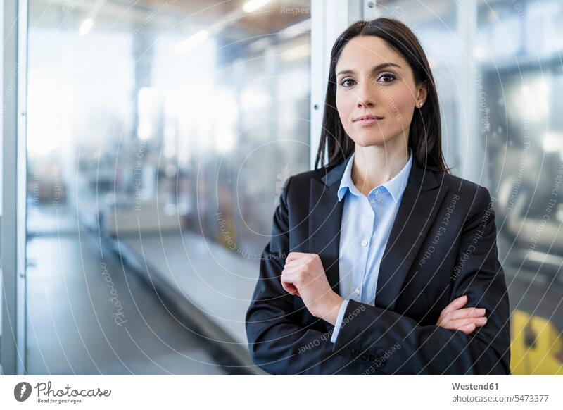 Portrait of confident businesswoman in a modern factory factories businesswomen business woman business women portrait portraits confidence contemporary