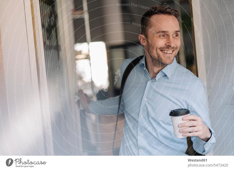 Businessman leaving coffee shope with take out coffee human human being human beings humans person persons caucasian appearance caucasian ethnicity european