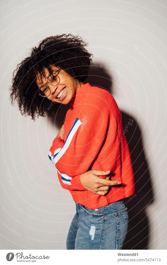 Smiling woman with arms crossed standing against white background color image colour image studio shot studio photograph studio photographs studio shots indoors