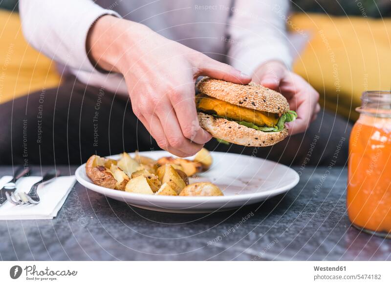 Close-up of man having a vegan burger with potatoes for lunch Glass Drinking Glasses healthy lifestyle healthy living Health Lifestyle healthy lifestyles