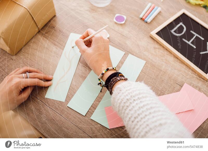 Young woman doing crafts with watercolour in her studio studios craftwork handcraft arts and crafts handicraft females women watercolours watercolors