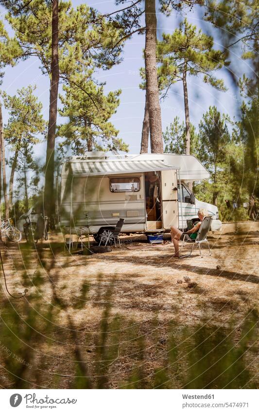 France, Gironde, woman sitting in front of camper on a camping ground using digital tablet digitizer Tablet Computer Tablet PC Tablet Computers iPad