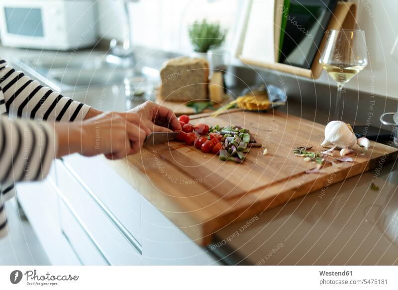 Close-up of woman cooking in kitchen at home cutting vegetables human human being human beings humans person persons celibate celibates singles solitary people