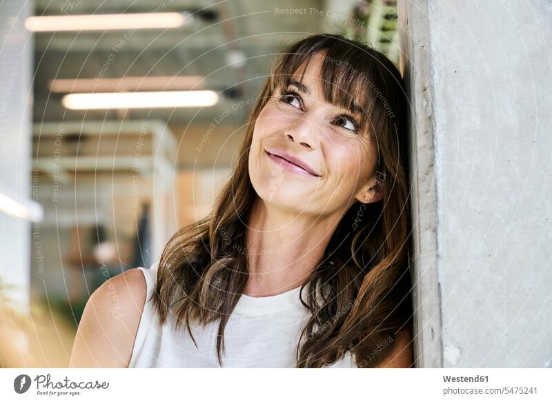 Woman looking up while leaning on wall at home color image colour image indoors indoor shot indoor shots interior interior view Interiors day daylight shot