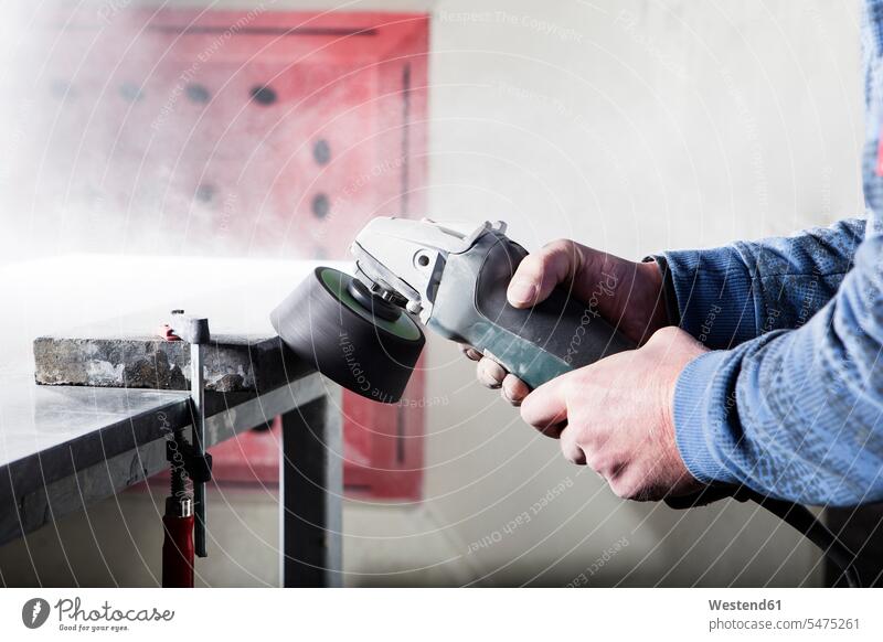 Stonemason working on stone with a grinding machine in his workshop stones grinder stonemason stonecutters stone cutters stonemasons At Work rock rocks craft