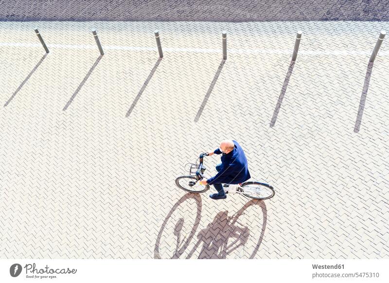 Mature man cycling on sunny day during pandemic illness color image colour image outdoors location shots outdoor shot outdoor shots daylight shot daylight shots