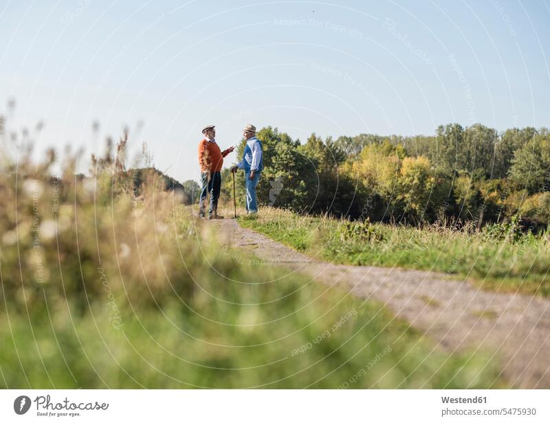 Two old friends standing in the fields, talking about old times speaking Stroll walk walking going Best Friend Best Friends Best Pal Field Fields farmland