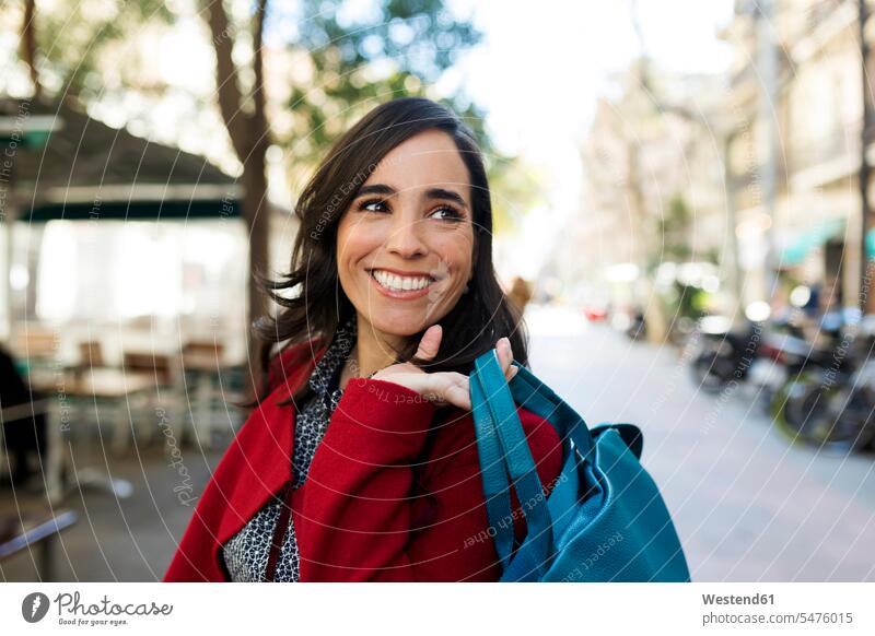 Portrait of happy woman in the city happiness portrait portraits town cities towns females women outdoors outdoor shots location shot location shots Adults