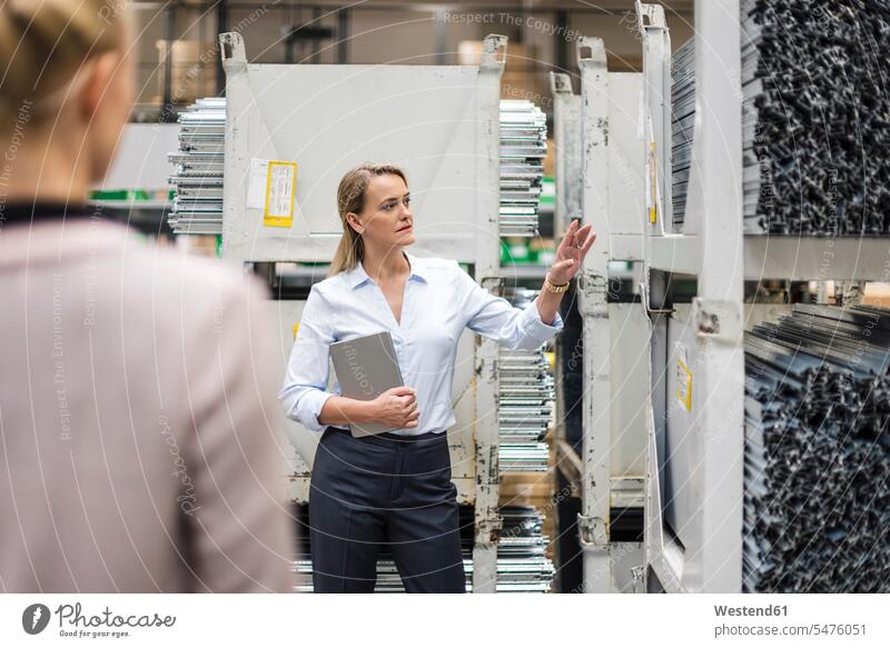 Woman with laptop in high rack warehouse tablet digitizer Tablet Computer Tablet PC Tablet Computers iPad Digital Tablet digital tablets colleagues working