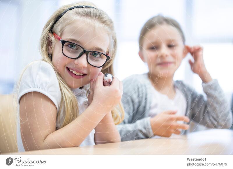 Portrait of smiling schoolgirl in class holding mouse female pupils School Girl schoolgirls School Girls mus mice schools schoolchildren education rodent