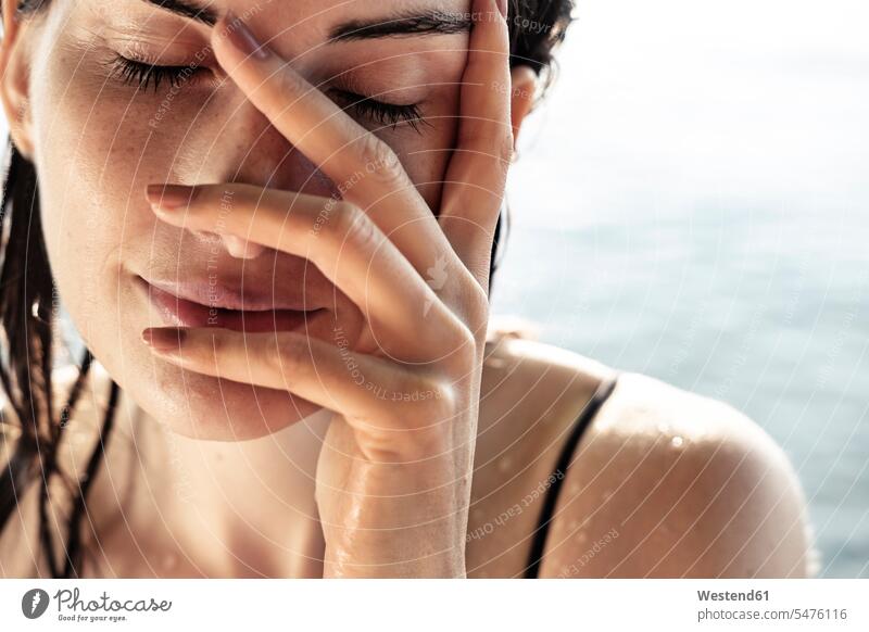 Woman with her hands over her face - a Royalty Free Stock Photo