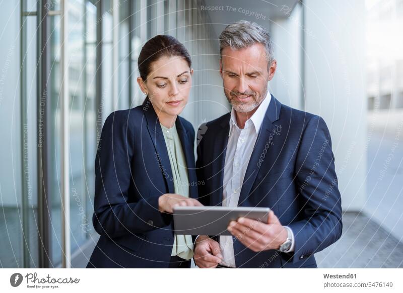 Portrait of two business partners looking together at tablet digitizer Tablet Computer Tablet PC Tablet Computers iPad Digital Tablet digital tablets portrait