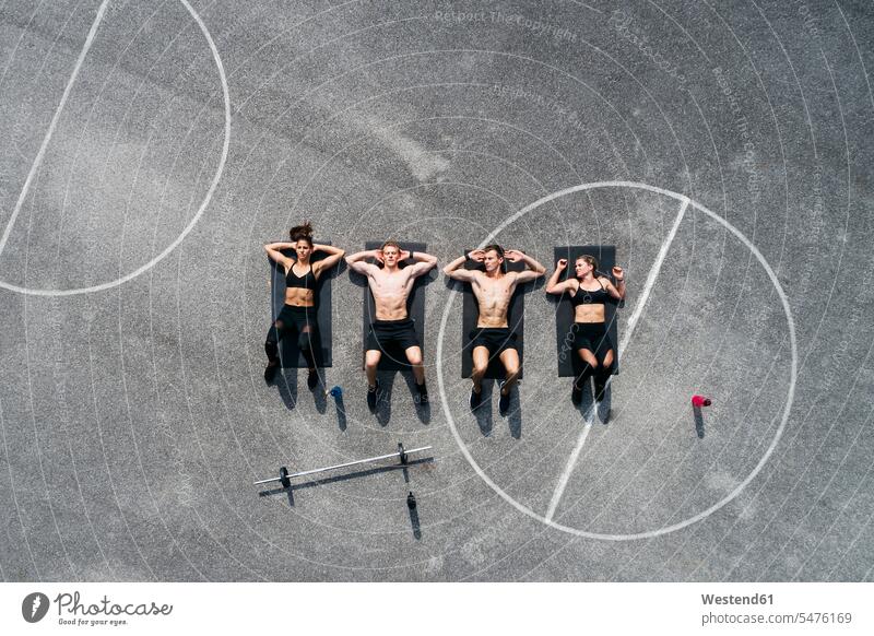 Group of young people in good shape, training on a sportsfield caucasian caucasian ethnicity caucasian appearance european healthy lifestyle healthy living