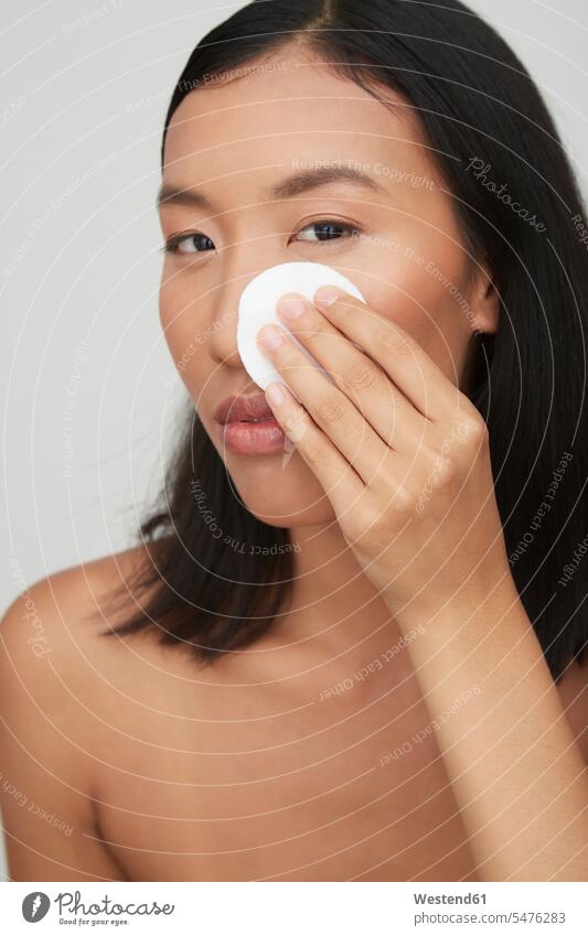 Portrait of young female Chinese woman, using cotton pad human human being human beings humans person persons Asian Asians 1 one person only only one person