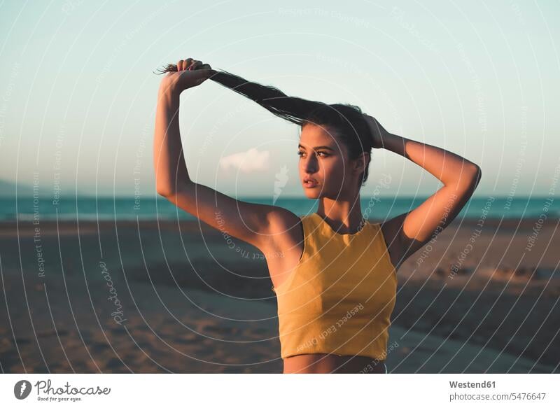 Portrait of teenage girl on the beach at sunset beaches sunsets sundown portrait portraits Teenage Girls female teenagers atmosphere atmospheric mood moody