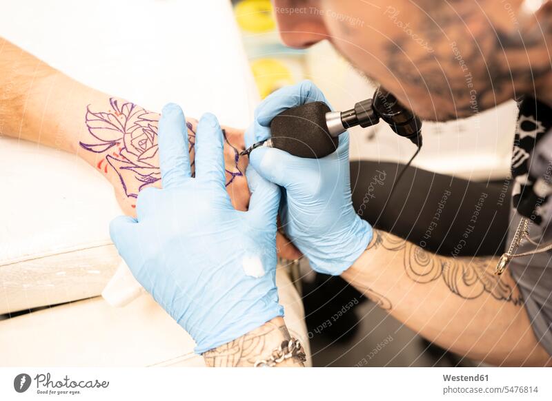 Tattoo artist tattoing hand tattoo tattoos tattoo artist tattooing tattooist tattooer human hand hands human hands tattooed body art Body Adornment Skin Art