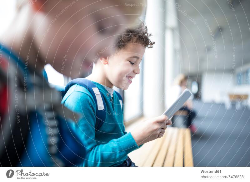 Smiling pupils with tablet on school corridor student hallway corridors hallways happiness happy schools digitizer Tablet Computer Tablet PC Tablet Computers