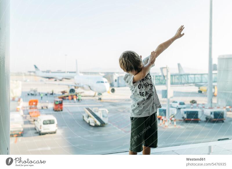 Spain, Barcelona airport, Boy in departure area, pretending to fly caucasian caucasian ethnicity caucasian appearance european tourist tourists Travel waiting