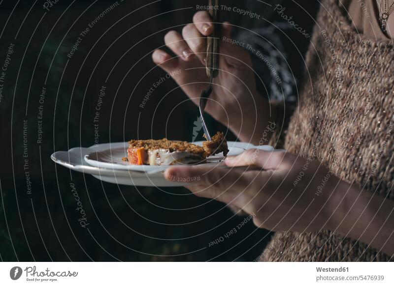 Woman eating home-baked Christmas cake, partial view home-made woman females women Christmas Cake Adults grown-ups grownups adult people persons human being