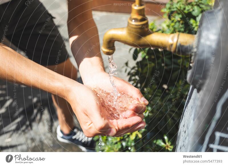 Close up on hands and water spilling from a public fountain water well water wells water fountain human hand human hands washing fountains people persons