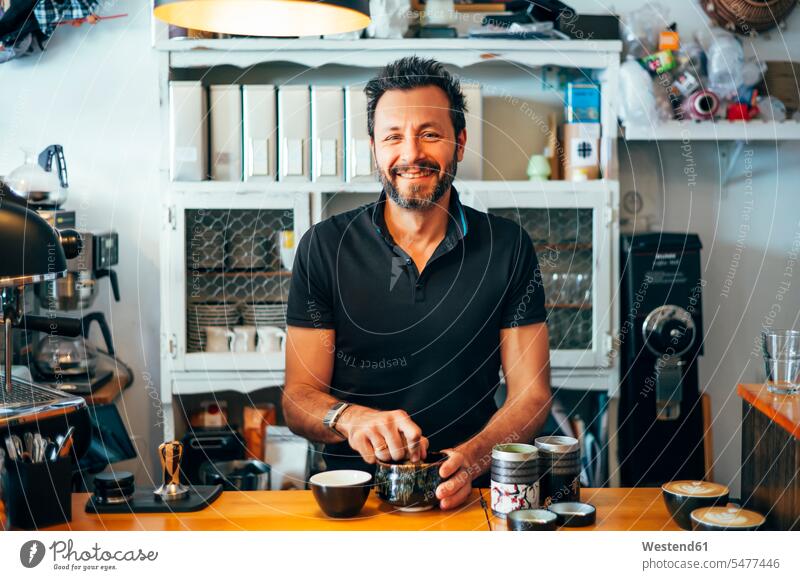 Portrait of smiling barista at the counter of a coffee shop cafe smile counters Barista Baristas Coffee Drink beverages Drinks Beverage food and drink Nutrition