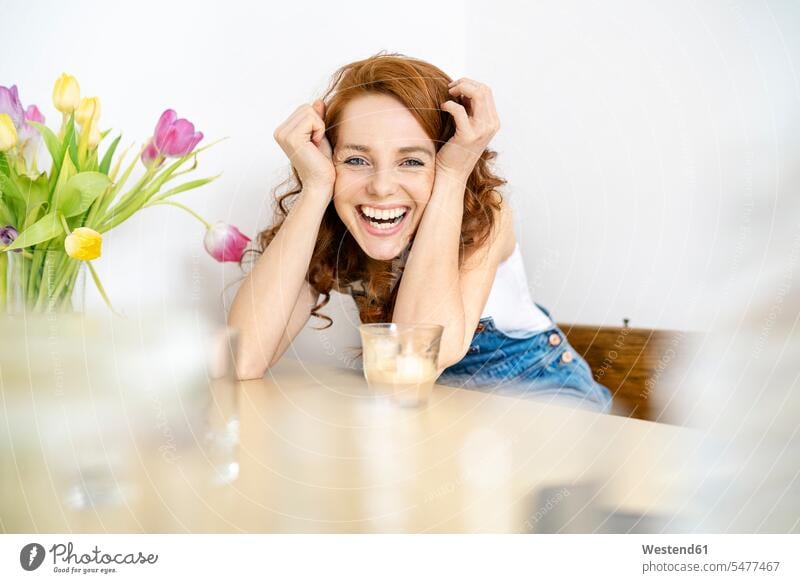 Portrait of cheerful mid adult woman with drink leaning on table at home beautiful Woman beautiful Women Beautiful People Handsome People Beauty 1new concepts