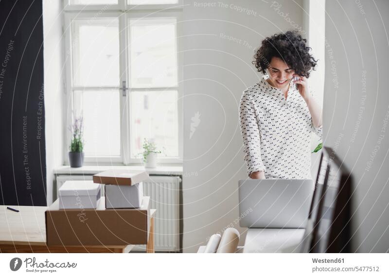 Smiling young woman on the phone using laptop in home office Occupation Work job jobs profession professional occupation business life business world