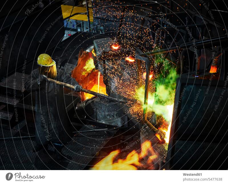 Industry, worker at furnace during melting copper, wearing a fire proximity suit Austria producing making Competence Skill smeltery Blast Furnace