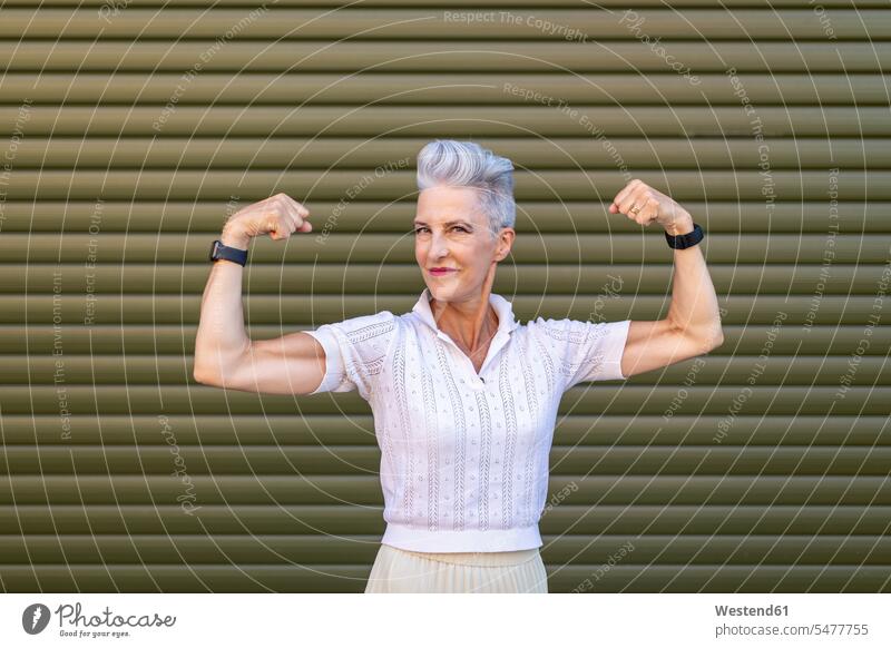 Woman Flexing Muscle Stock Photo, Royalty-Free