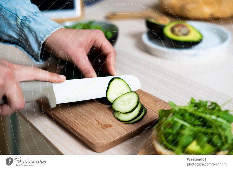 Hands of woman slicing cucumber on cutting board indoors indoor shot indoor shots interior interior view Interiors day daylight shot daylight shots day shots