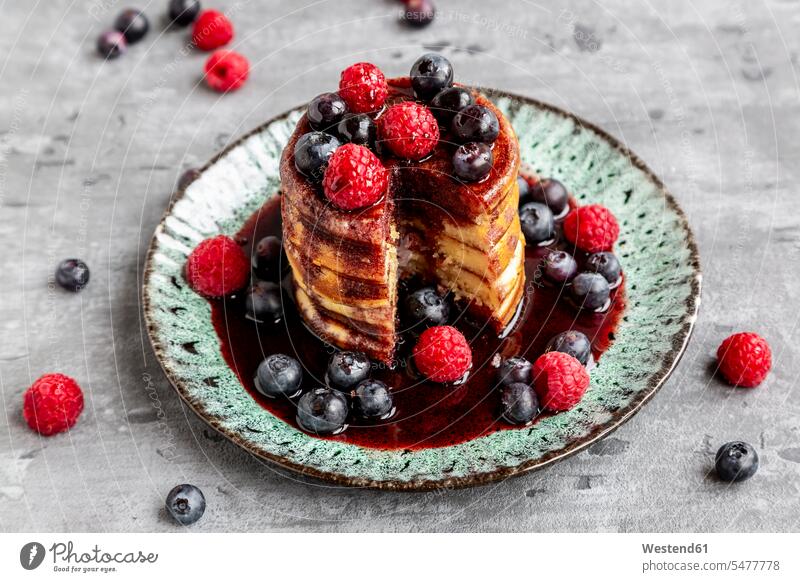 Pancakes with blueberries, raspberries and black currant sirup Plate dish dishes Plates fruit garnished ready to eat ready-to-eat blueberry bilberry bilberries