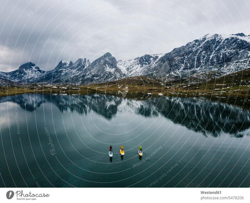 Aerial view of three people stand up paddle surfing, Leon, Spain sports aquatics Water Sport watersports surf ride surf riding Surfboarding surf board