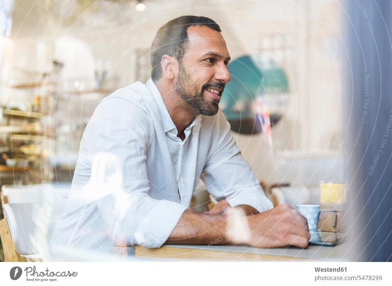 Smiling man with tablet in a cafe digitizer Tablet Computer Tablet PC Tablet Computers iPad Digital Tablet digital tablets men males smiling smile computer