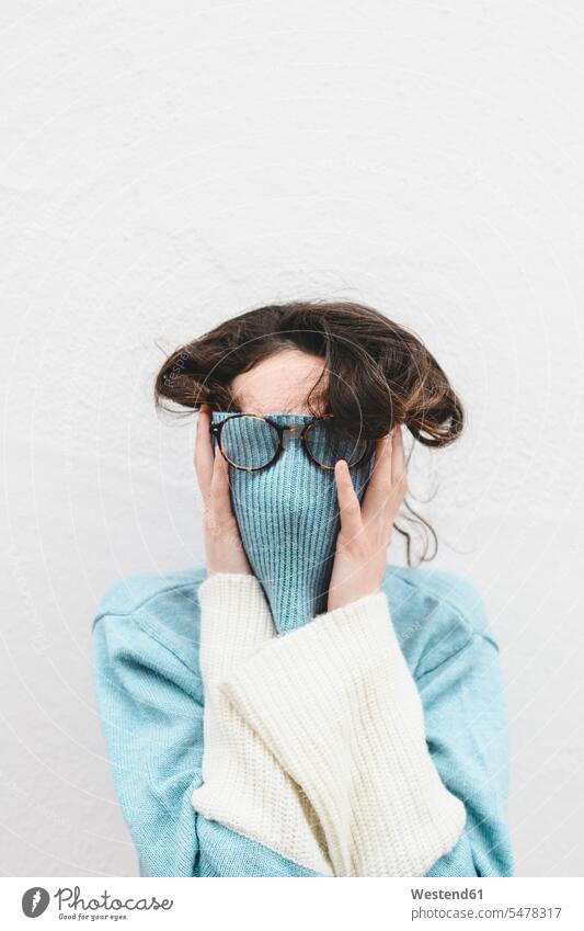 Young woman covering her face with turtle neck Eye Glasses Eyeglasses specs spectacles hide colour colours White Colors Humor Humorous Lifestyle fashionable