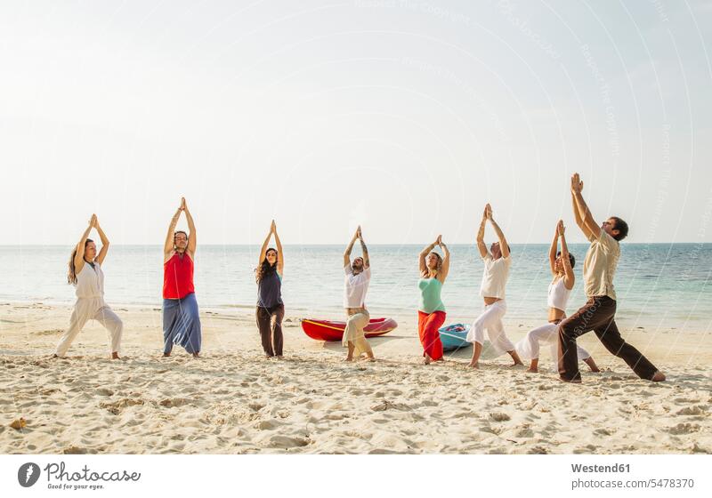 Thailand, Koh Phangan, group of people doing yoga on a beach practicing practice practise exercise exercising practising beaches Yoga Group groups of people