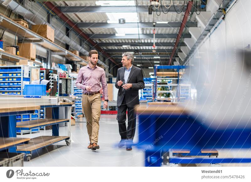 Businessmen during meeting in production hall Businessman Business man Business men factory factories males discussion discussing entrepreneur entrepreneurs