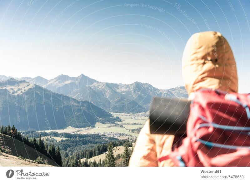 Austria, Tyrol, rear view of man on a hiking trip in the mountains enjoying the view mountain range mountain ranges men males indulgence enjoyment savoring