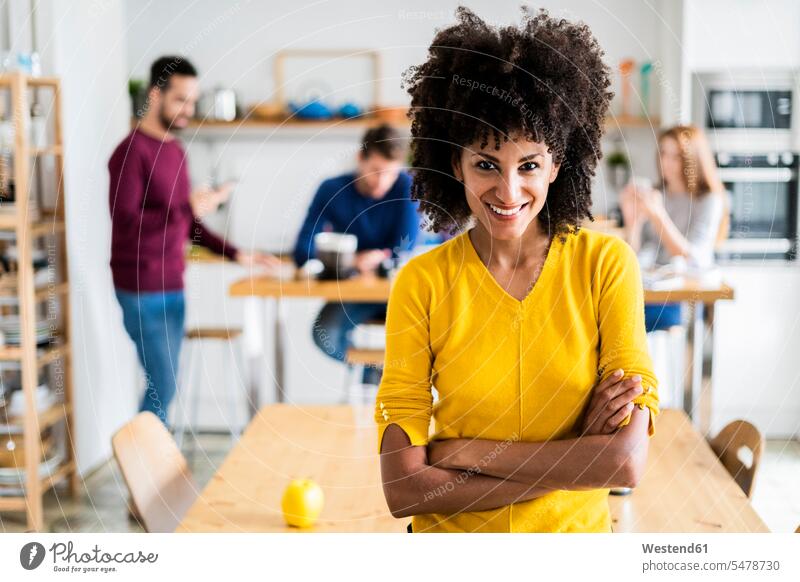 Portrait of smiling woman at dining table at home with friends in background human human being human beings humans person persons caucasian appearance