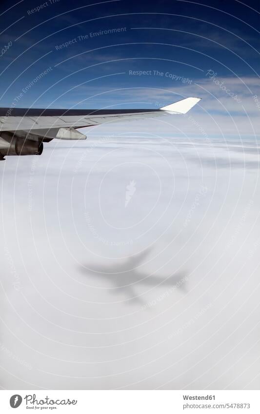 Jumbo jet, Boeing 747 in mid-air, view at clouds shadow of the airplane air traffic air transport high height altitude wing shadows silhouette silhouettes day