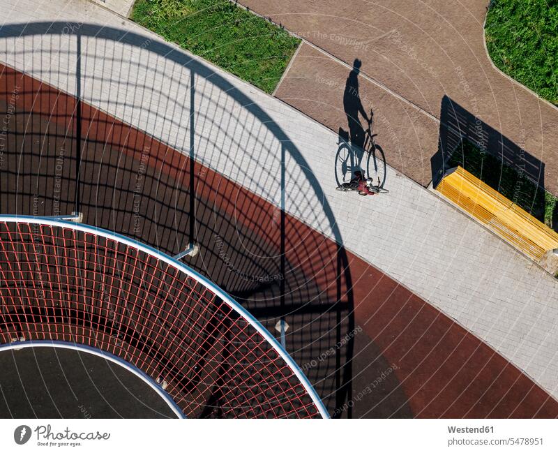 Man cycling on path in sports field, aerial view outdoors location shots outdoor shot outdoor shots day daylight shot daylight shots day shots daytime