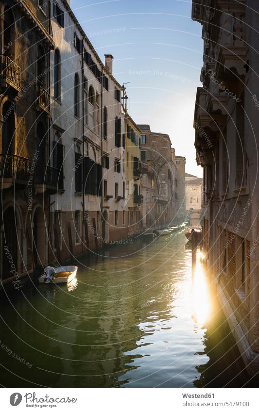 Italy, Veneto, Venice, Old houses along narrow city canal at dusk outdoors location shots outdoor shot outdoor shots evening twilight in the evening