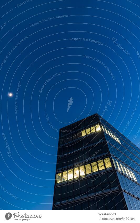 Germany, Stuttgart, lighted windows at modern office building at blue hour lighting Illuminating lit contemporary At Work work Building Exteriors front