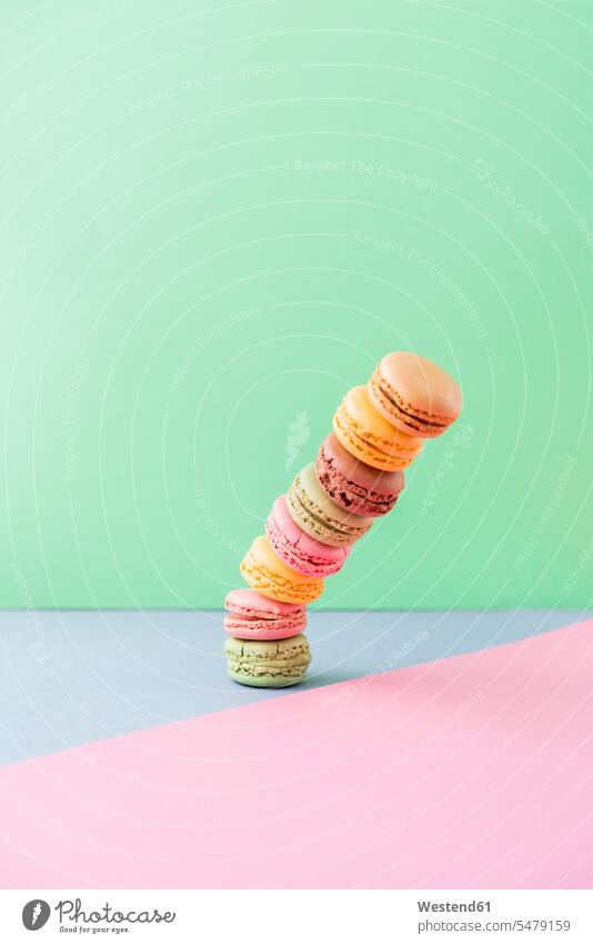 Studio shot of stack of pastel colored macaroon cookies falling down studio shot studio photograph studio photographs studio shots indoors indoor shot