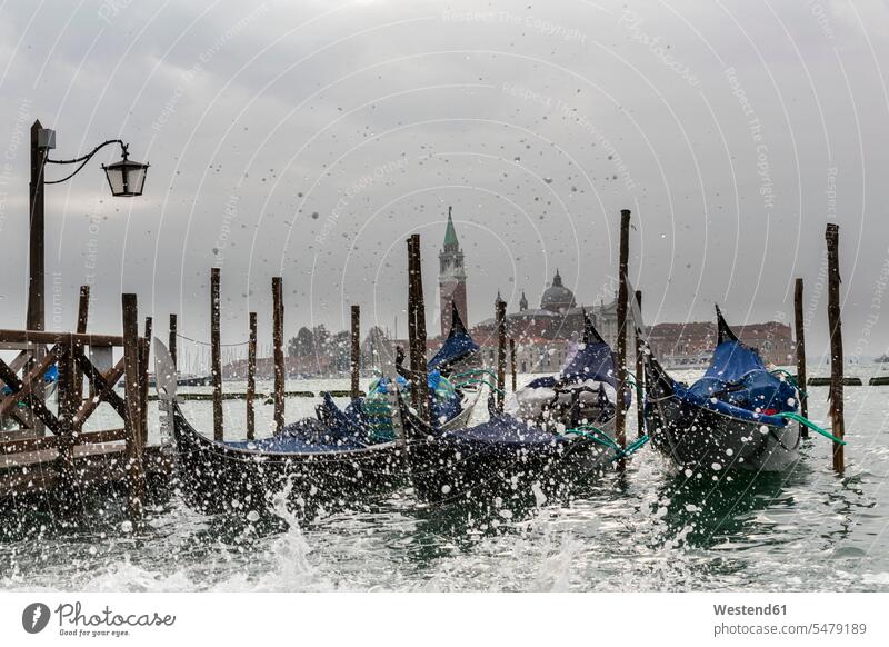 Italy, Venice, Gondolas and church San Giorgio Maggiore at high watermark Travel splash water splash of water churches landmark sight place of interest sky