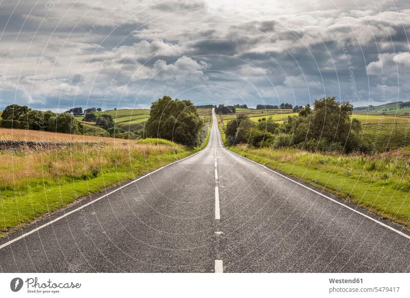 Clouds over empty countryside highway at dawn outdoors location shots outdoor shot outdoor shots tarmac asphalt Blacktop country road country roads rural road