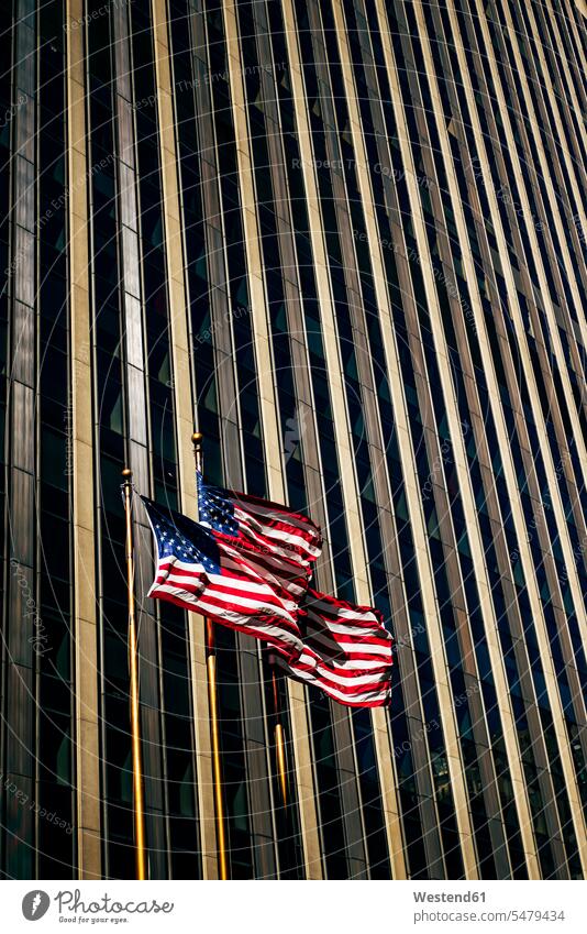 USA, New York, New York City, Three American flags against skyscraper outdoors location shots outdoor shot outdoor shots day daylight shot daylight shots