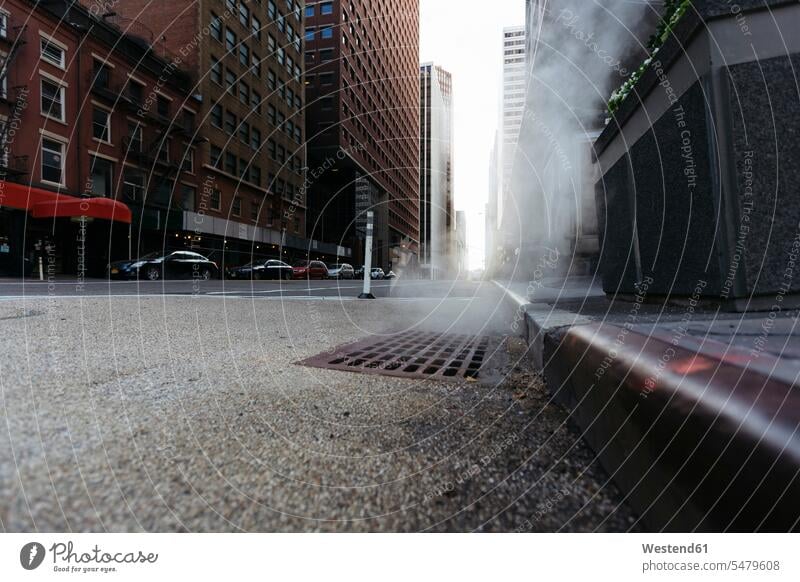 USA, New York City, Downtown Manhattan, haze coming out of a gully in the morning curb kerb surface level worm's eye view journey travelling voyage tarmac