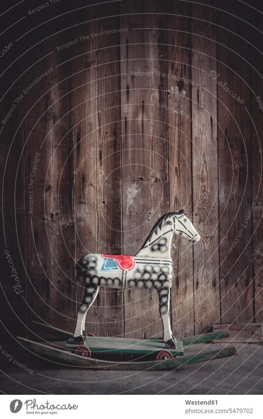 Vintage rocking horse in a barn in front of a wooden wall nobody Nostalgia nostalgic decorative decoratively side view sideview single object 1 one copy space