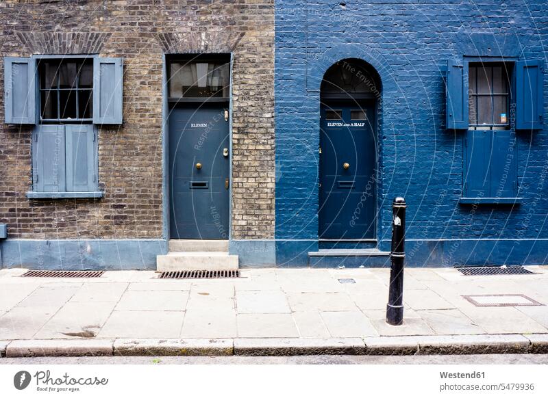 UK, London, Whitechapel, entrances and windows of two houses capital Capital Cities Capital City pavement house front bollard round rounding roundings Part Of